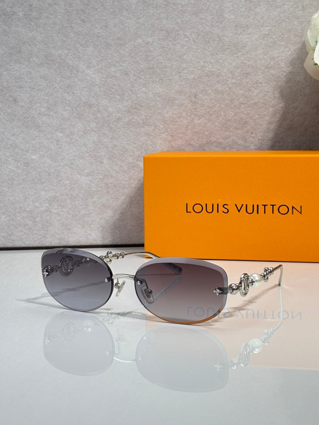 Louis Vuitton sunglasses with dark lenses and silver-toned metal frame