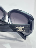 Sunglasses hinge close-up with metal logo plate