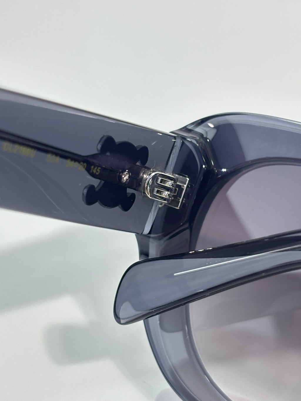 Sunglasses temple close-up with metal logo detail