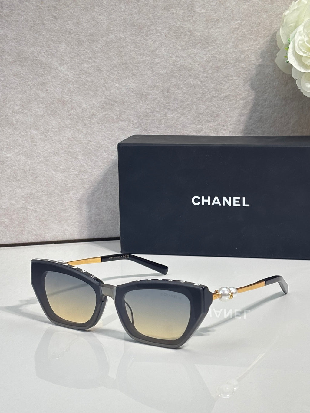 Chanel cat-eye sunglasses with dark acetate frames and smoky gray lenses