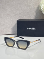 Chanel cat-eye sunglasses with dark acetate frames and smoky gray lenses