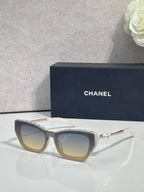 Chanel cat-eye sunglasses with dark acetate frames and champagne-tinted lenses