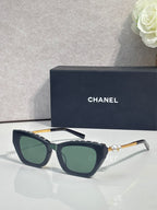 Chanel cat-eye sunglasses with dark acetate frames and green-tinted lenses