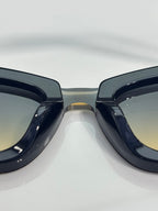 Chanel cat-eye sunglasses close-up with glossy dark frames and tinted lenses