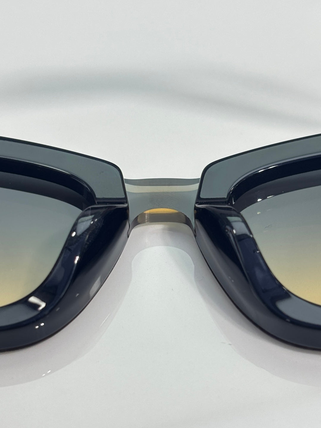 Chanel cat-eye sunglasses close-up with glossy dark frames and tinted lenses