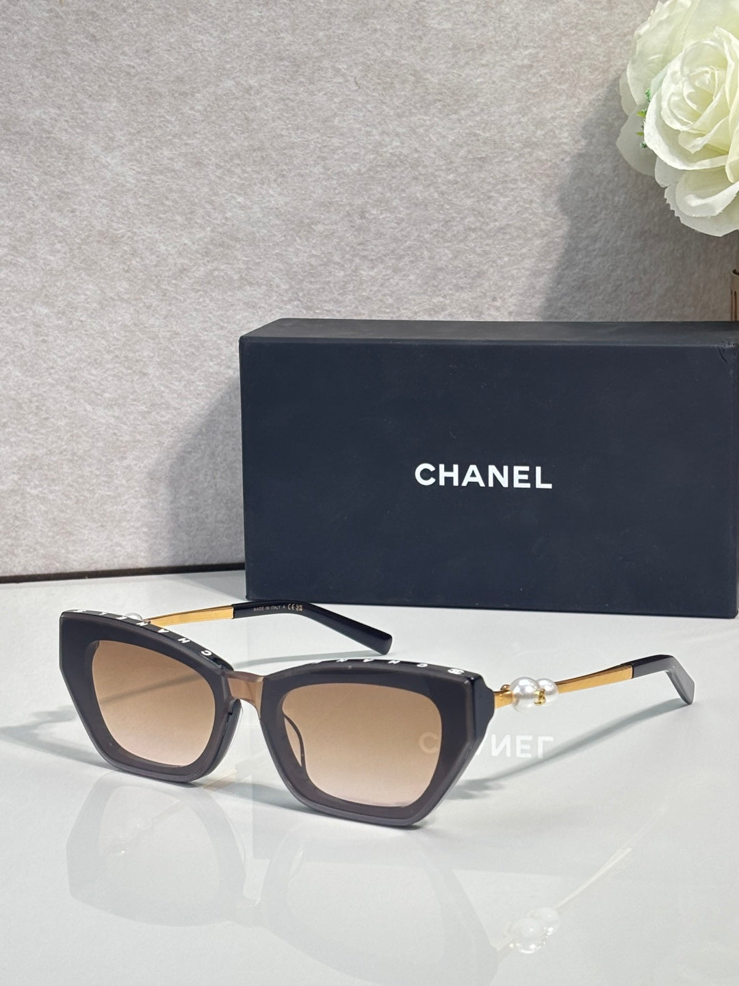 Chanel cat-eye sunglasses with dark acetate frames and brown-tinted lenses