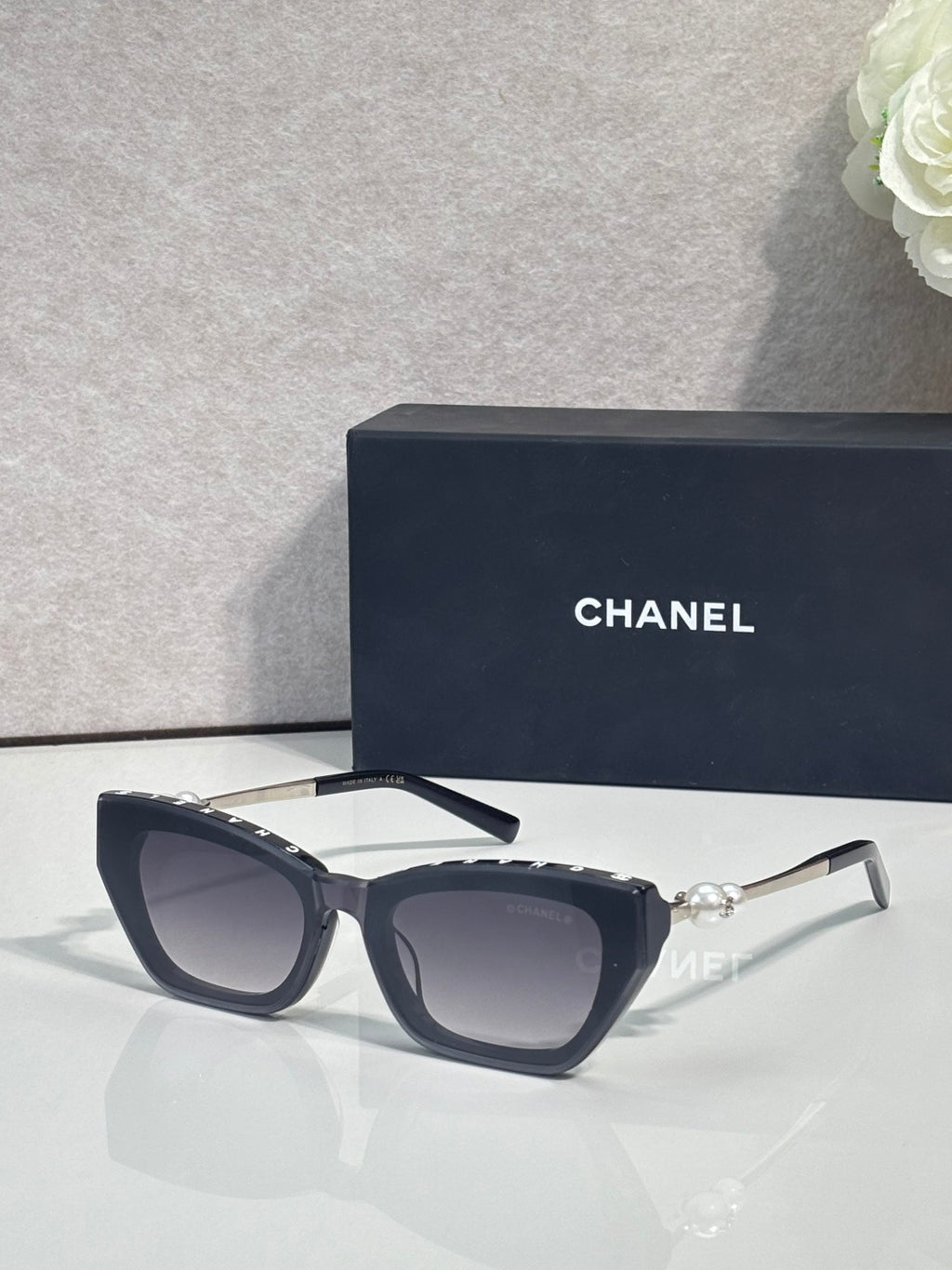 Chanel cat-eye sunglasses with dark acetate frames and light gray lenses