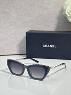 Chanel cat-eye sunglasses with dark acetate frames and light gray lenses