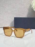 Sunglasses with amber frame and gradient lenses, gold-tone temple details