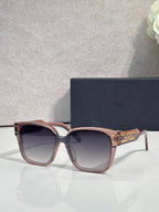 Sunglasses with rose-tinted frame and gradient lenses, gold-tone temple details