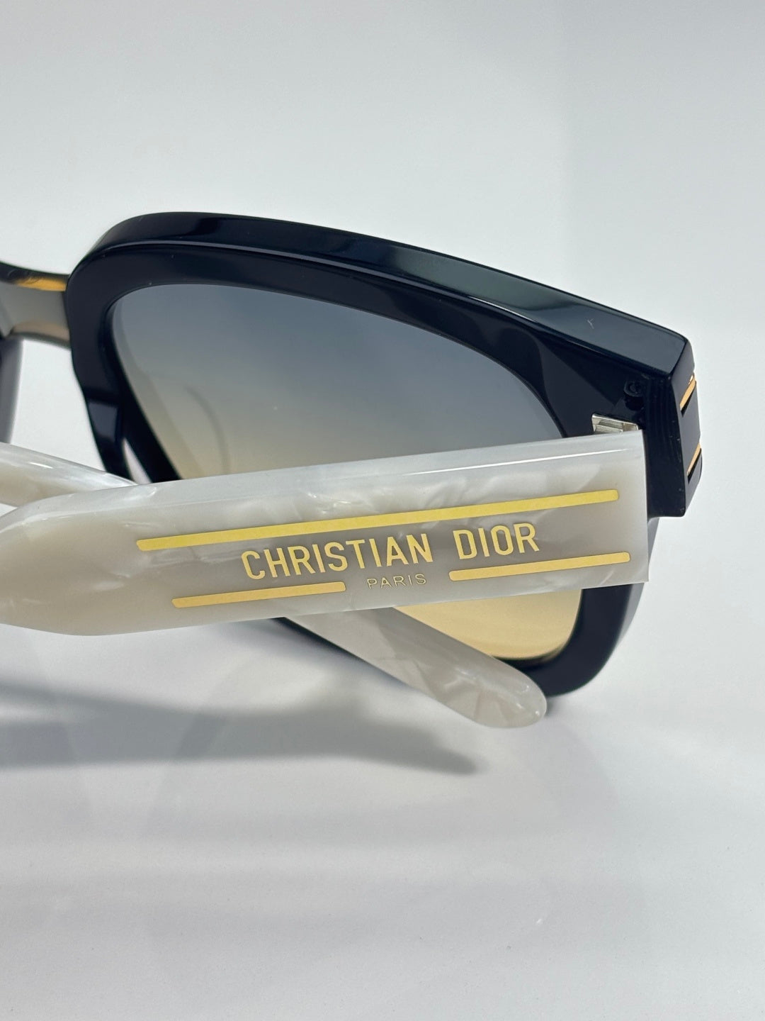 Sunglasses temple arm with gold CHRISTIAN DIOR lettering and dark frame