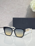 Sunglasses with black acetate frame and gradient lenses, gold logo detail at temple