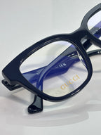 Rectangular eyeglasses with dark navy frame and blue-tinted inner lens, clear lenses