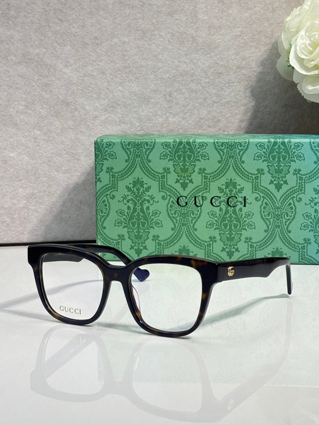 Rectangular eyeglasses with dark navy glossy frame and clear lenses