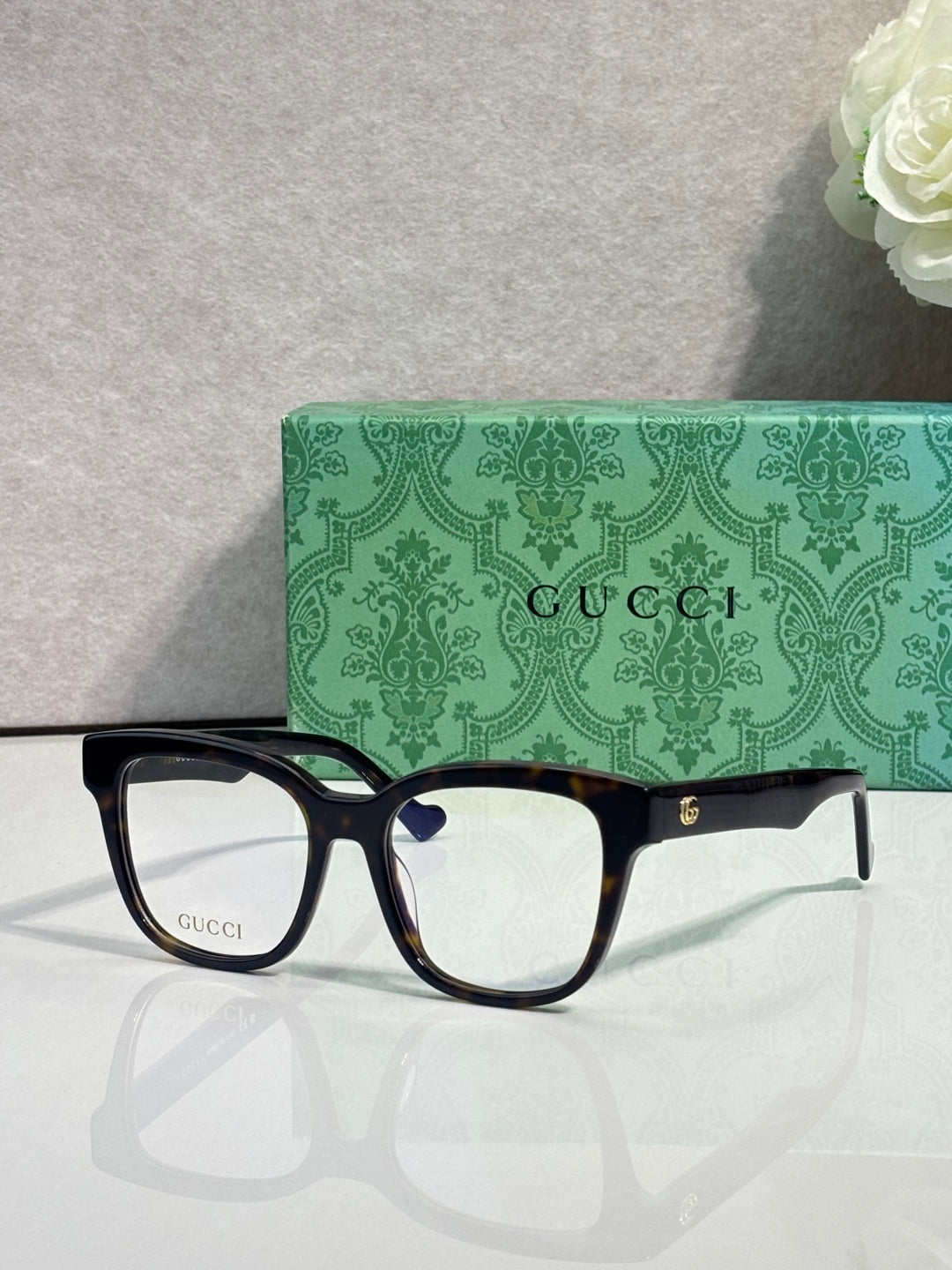 Rectangular eyeglasses with dark navy glossy frame and clear lenses