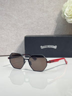 Chrome sunglasses with dark octagonal lenses, black frame, and red side arms