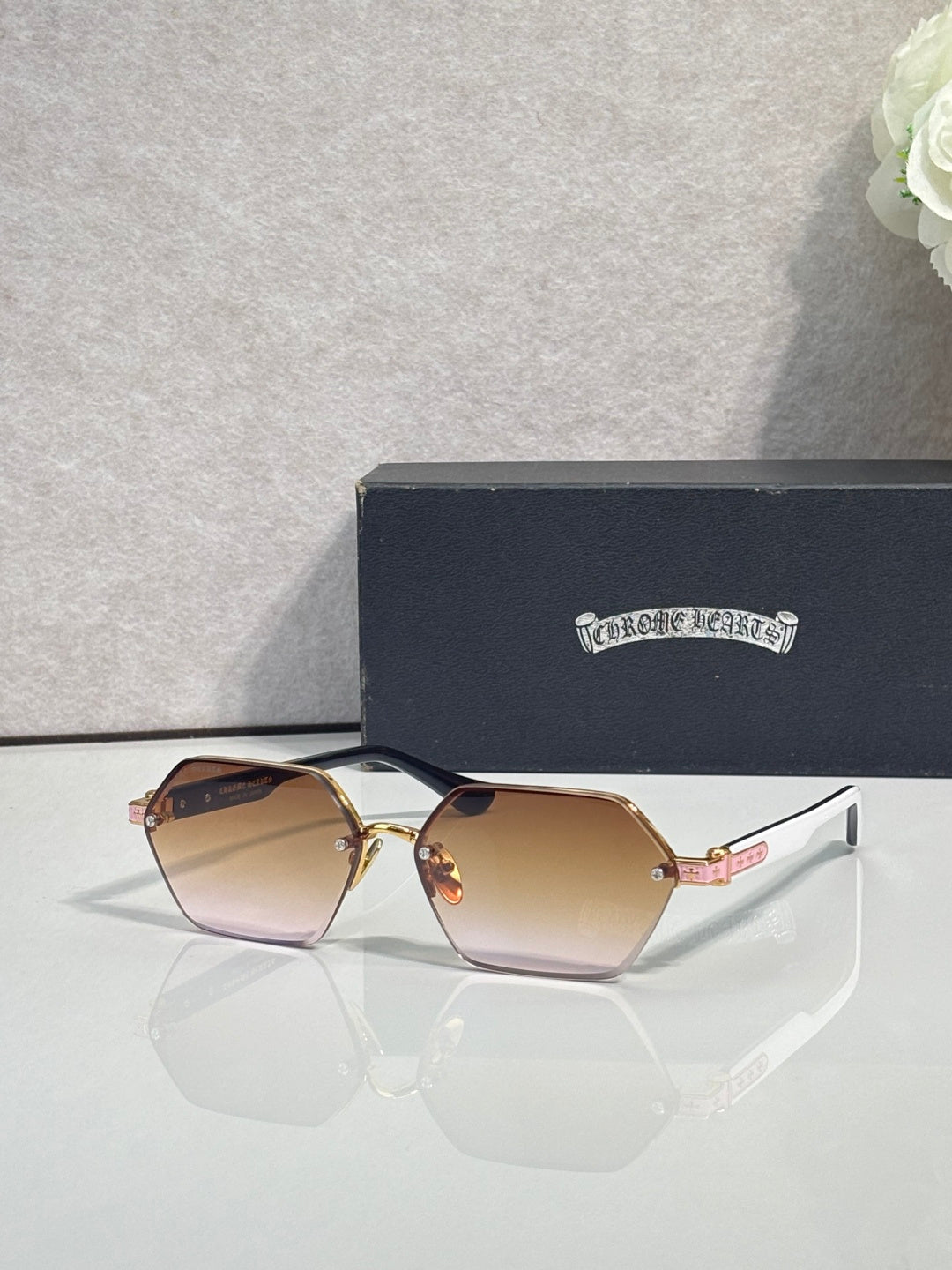 Hexagon sunglasses with gradient brown lenses and rose-gold metal frame, gold details