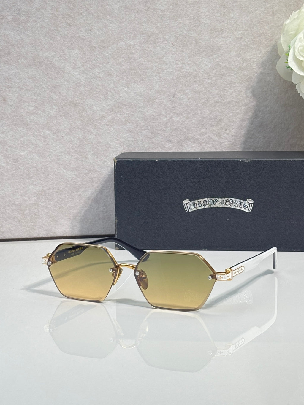 Hexagon sunglasses with yellow-gold lenses and gold metal frame, white temple tips