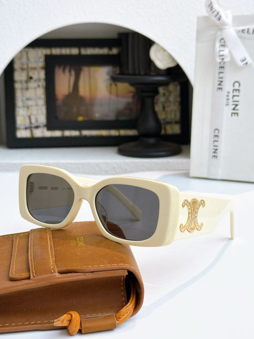 Celine sunglasses with cream frames and gold logo on temple, dark lenses