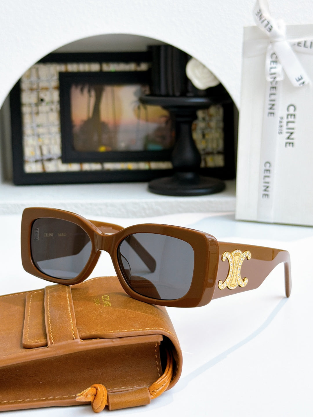 Celine sunglasses with brown frames and gold logo on temple, dark lenses