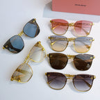 MiuMiu gold sunglasses assortment with various tinted lenses arranged together