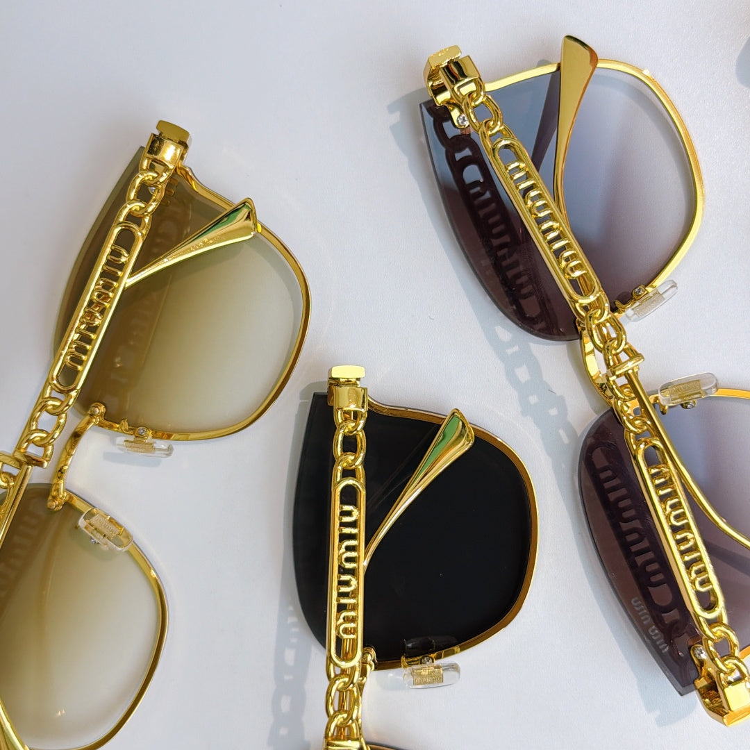 MiuMiu gold sunglasses close-up, tinted lenses and chain-style temple details