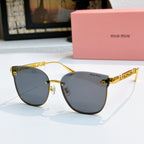 MiuMiu sunglasses with gold frames and dark gray tinted lenses, cat-eye style
