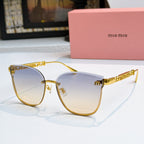 MiuMiu sunglasses with gold frames and light blue tinted lenses, cat-eye style