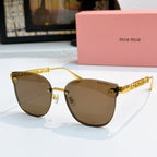 MiuMiu sunglasses with gold frames and brown tinted lenses, cat-eye style