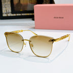 MiuMiu sunglasses with gold frames and light yellow tinted lenses, cat-eye style
