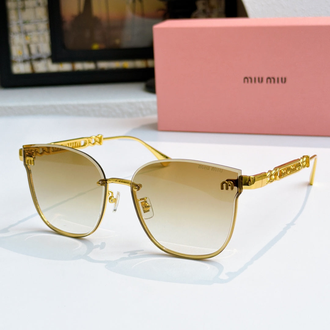 MiuMiu sunglasses with gold frames and light yellow tinted lenses, cat-eye style