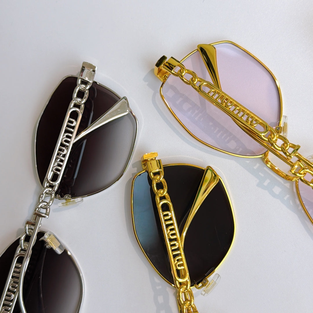 MiuMiu glasses in silver and gold with cat-eye frames, chain details, dark lenses