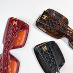 Assorted square sunglasses frames with tinted lenses in red, dark brown, and black