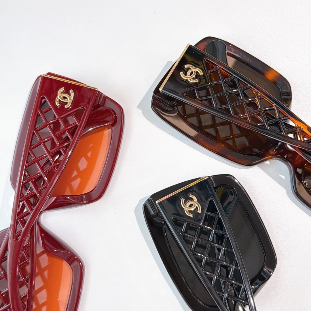 Assorted square sunglasses frames with tinted lenses in red, dark brown, and black