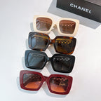 Set of square sunglasses with tinted lenses in cream, gray, brown, teal, and red frames
