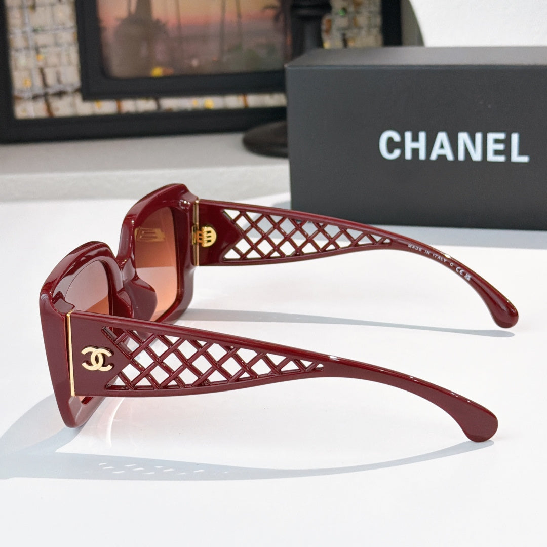 Red sunglasses side view with lattice temple and gold CC logo, tinted lenses
