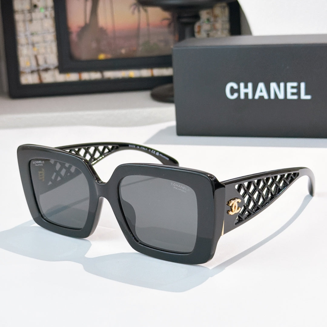 Square sunglasses with dark gray frame and gray-tinted lenses, lattice temple detailing