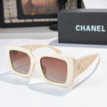 Square sunglasses with cream frame and rose-tinted lenses, lattice temple details