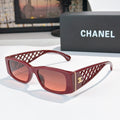 Red sunglasses with diamond-pattern temples and gold Chanel logo
