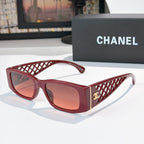 Red sunglasses with diamond-pattern temples and gold Chanel logo