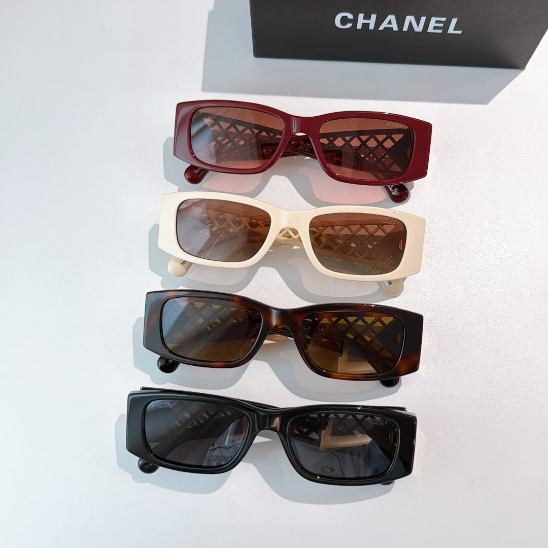 Chanel sunglasses assortment with red, cream, brown, and black frames