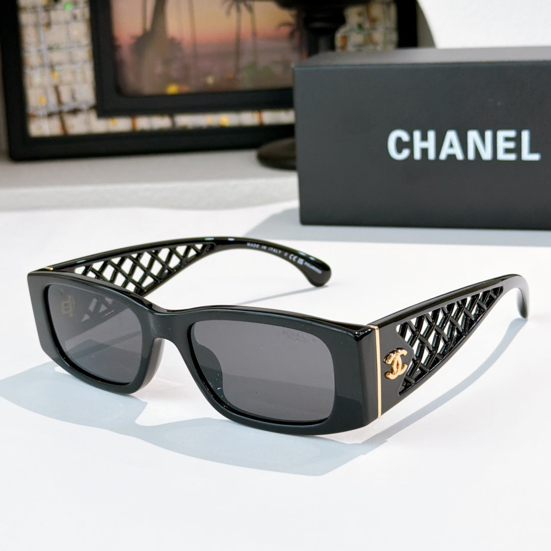 Black sunglasses with diamond-pattern temples and gold Chanel logo
