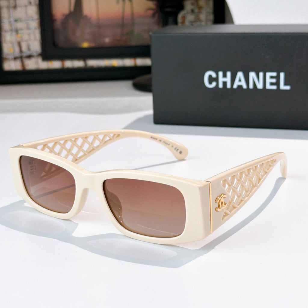 Cream sunglasses with diamond-pattern temples and gold Chanel logo