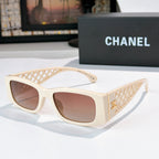 Cream sunglasses with diamond-pattern temples and gold Chanel logo