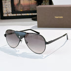 Dark framed aviator sunglasses with smoky gray lenses and blue temple accents