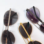 Cartier sunglasses set with mixed frames and dark lenses, shown stacked