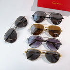 Cartier sunglasses display with mixed frames and tinted lenses on a white surface