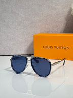 Louis Vuitton sunglasses with dark lenses, black frames, and gold-tone arms