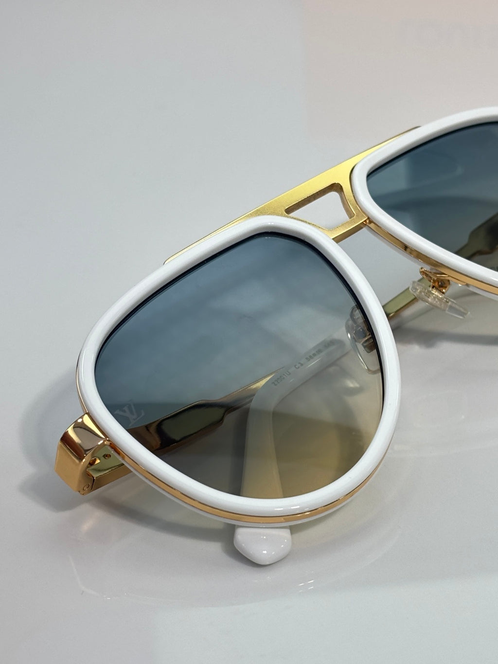 Louis Vuitton sunglasses with white frames and blue mirrored lenses