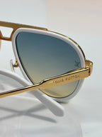 Louis Vuitton sunglasses close-up, white frame with gold-tone bridge and lens logo